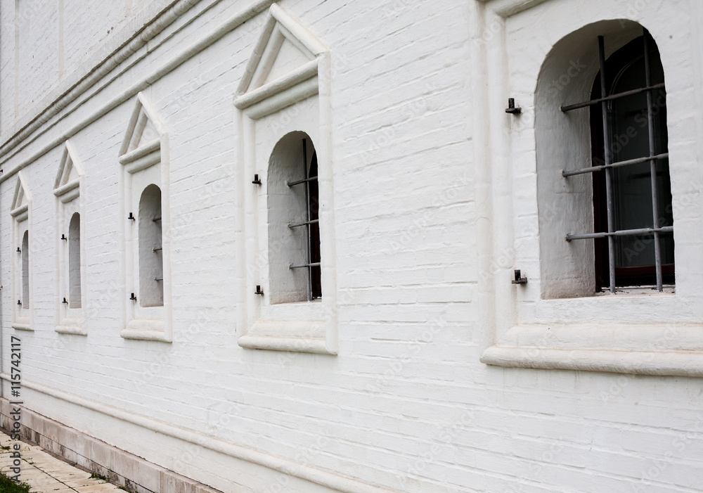 Fototapeta premium Barred windows in white brick wall