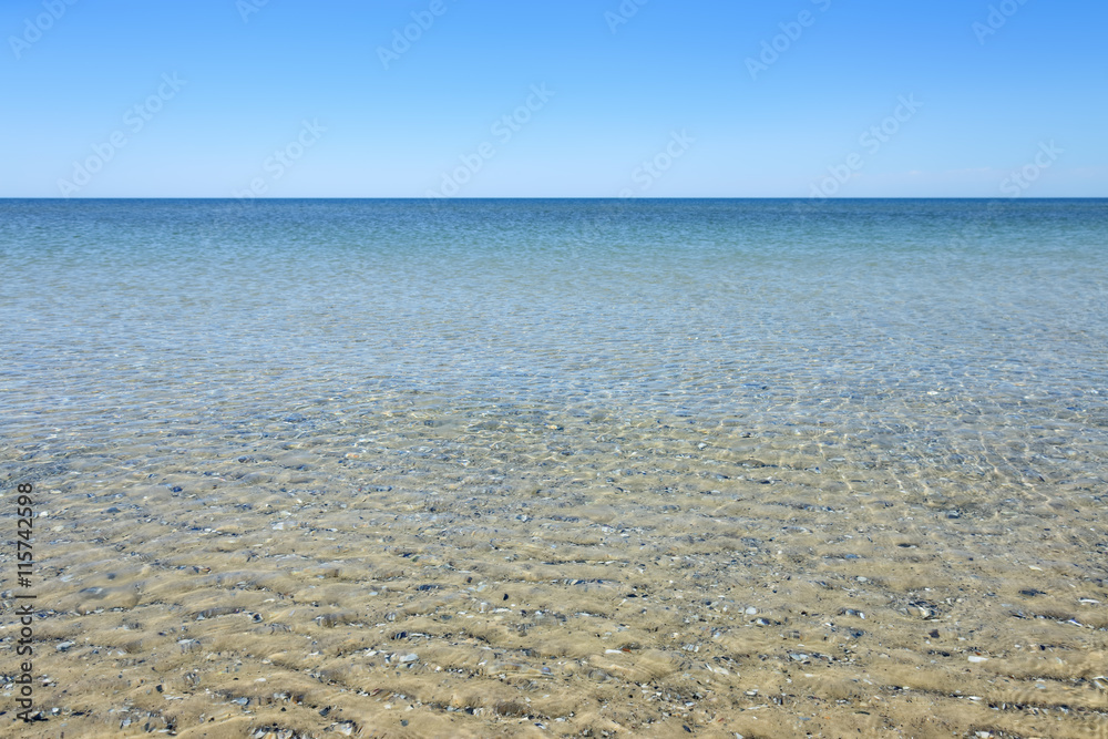Calm sea surface near coastline. Seascape in sunny day under clear skies. Calm sea surface near coastline. Seascape in sunny day under clear skies.