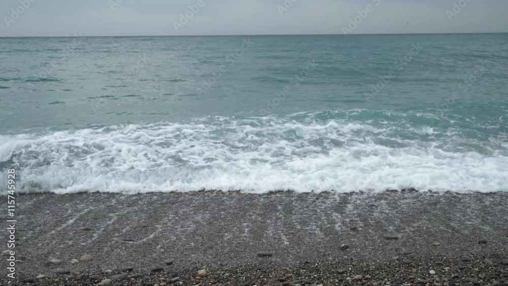 Waves are lapping against the seaside and the sea gravel. It is a morning time and the scenery looks magnificent. Waves are lapping against the seaside and the sea gravel. It is a morning time and the scenery looks magnificent.