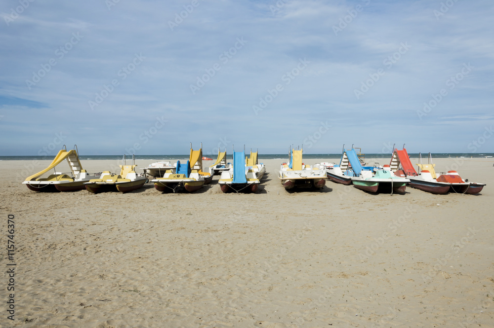 Colorful series of pedalo parked on the beach