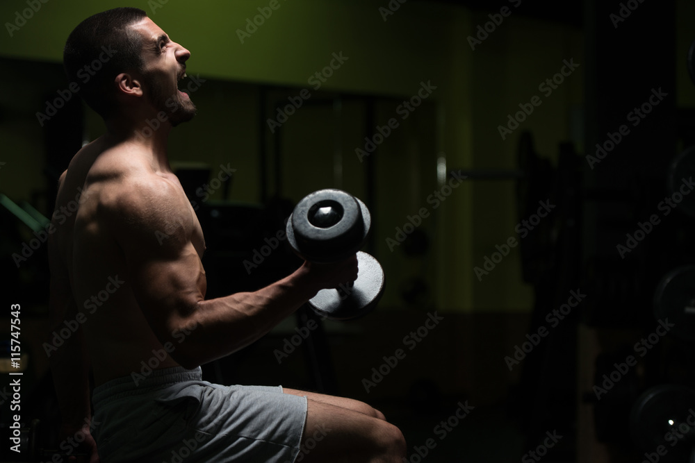 Plakat Young Man With Dumbbells Exercising Biceps