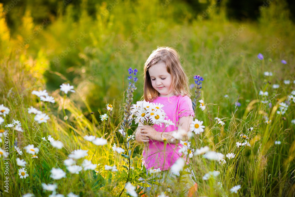 Little girl in daisy flower field Little girl in daisy flower field