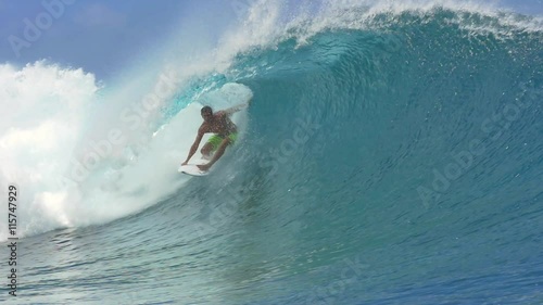 SLOW MOTION: Extreme surfer surfing inside big tube barrel wave