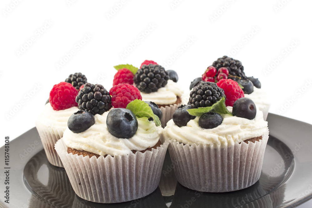 Elegant Cupcakes with Berries on the Black Plate Elegant Cupcakes with Berries on the Black Plate