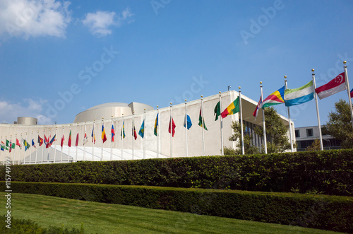 UN United Nations general assembly building with world flags fly