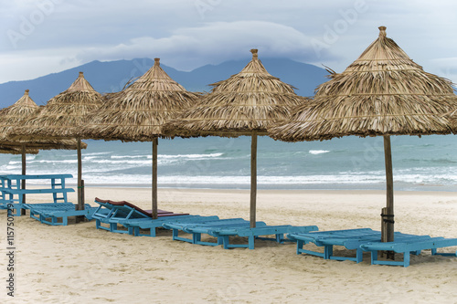 Palm shelters and sunbeds in the Beach in Da Nang