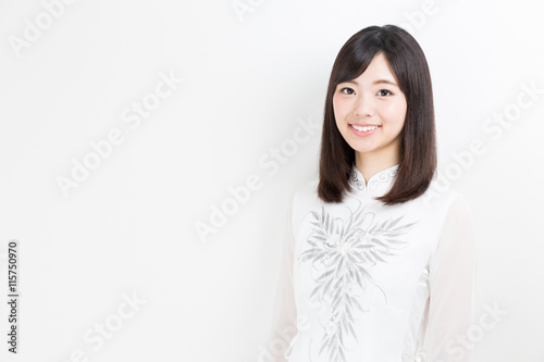portrait of young asian woman wearing ao dai © taka