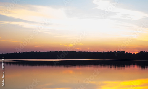 Sunset on forest lake grass on the shore © dmitry3299