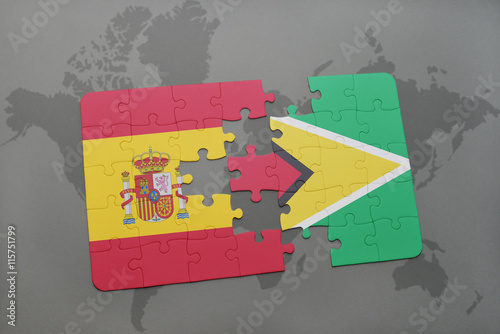 puzzle with the national flag of spain and guyana on a world map background.