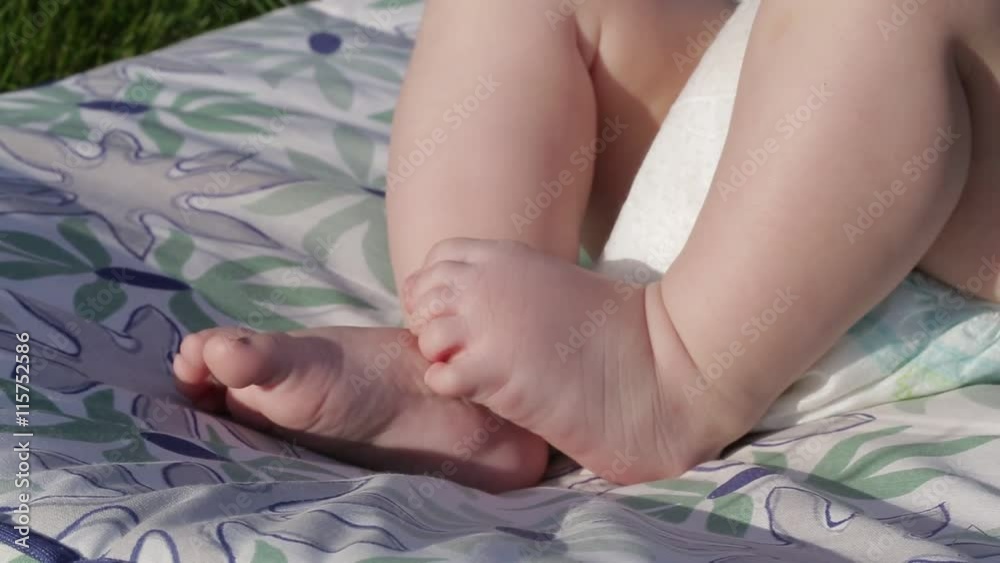 small baby's cute feet on the grass small baby's cute feet on the grass