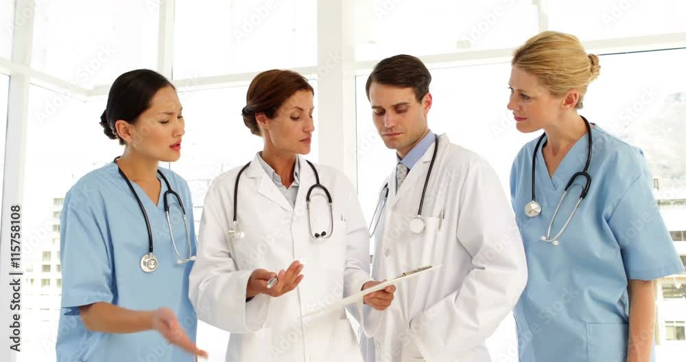 Medical team discussing a file Medical team discussing a file