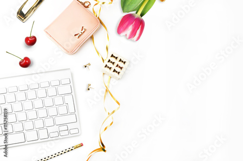 Table view office items, keyboard and flower white background mock-up, woman desk. Office desktop,gold items. Flat lay. Invitation template, gold polka. 