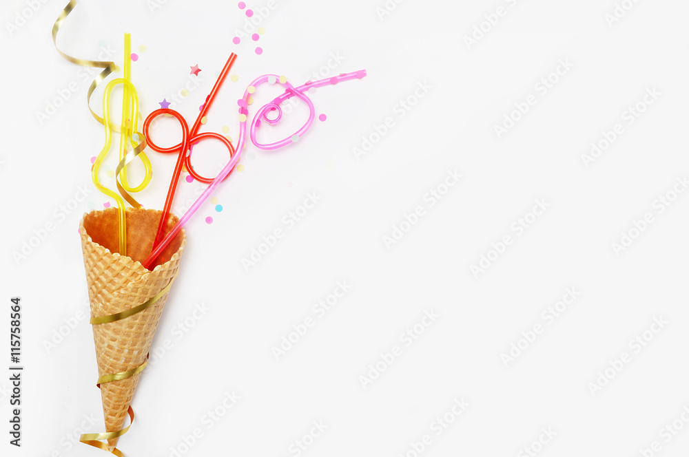 Waffle cone and tubes for cocktails on a white background, festive. Party background. flat lay Waffle cone and tubes for cocktails on a white background, festive. Party background. flat lay
