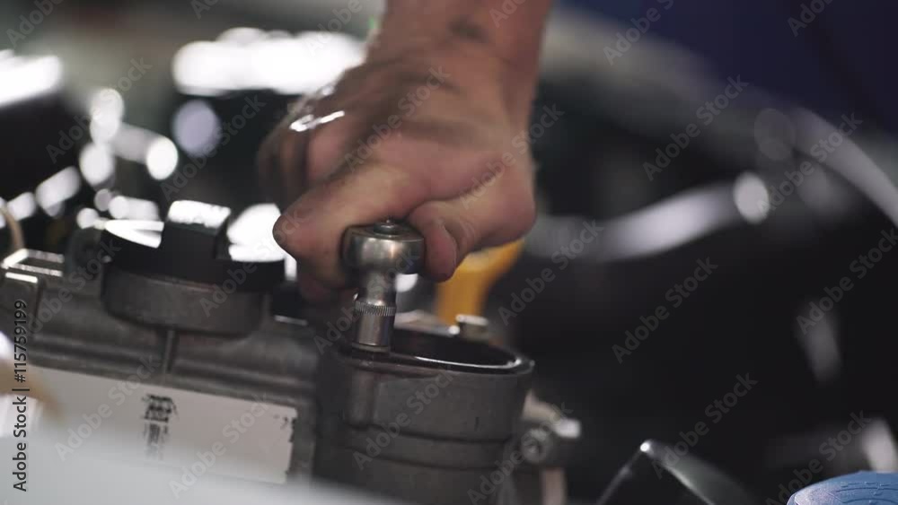 Auto mechanic repair engine in a car repair shop Auto mechanic repair engine in a car repair shop