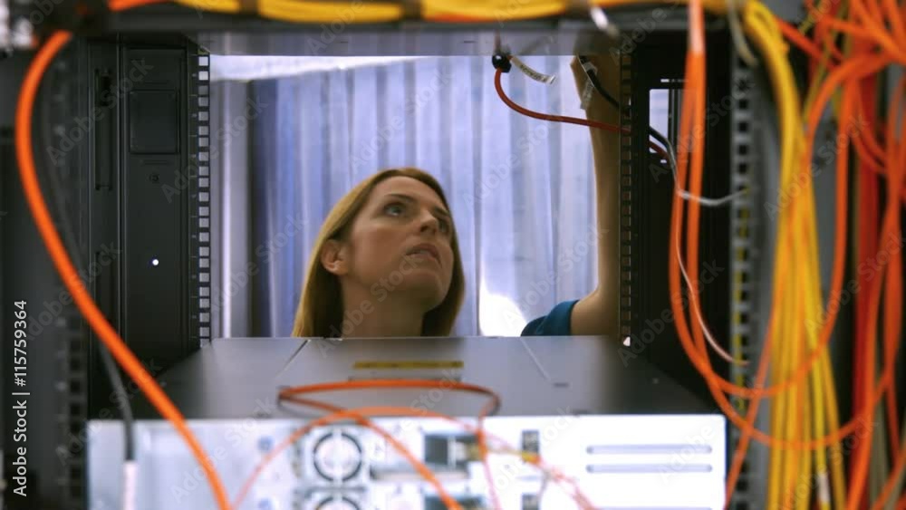 Technician looking at open server locker