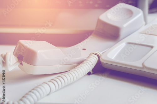 Office phone,Business telephone handset off the hook on desk