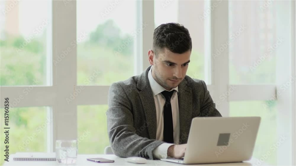 Businessman gets very good news on his computer monitor. Slow motion Businessman gets very good news on his computer monitor. Slow motion