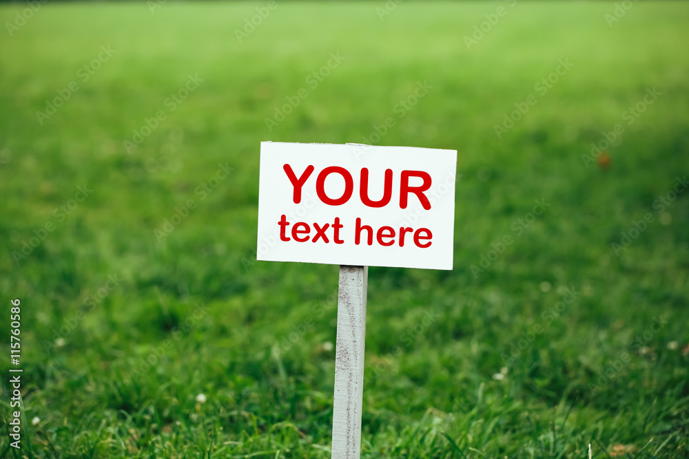 your text here sign against green lawn background