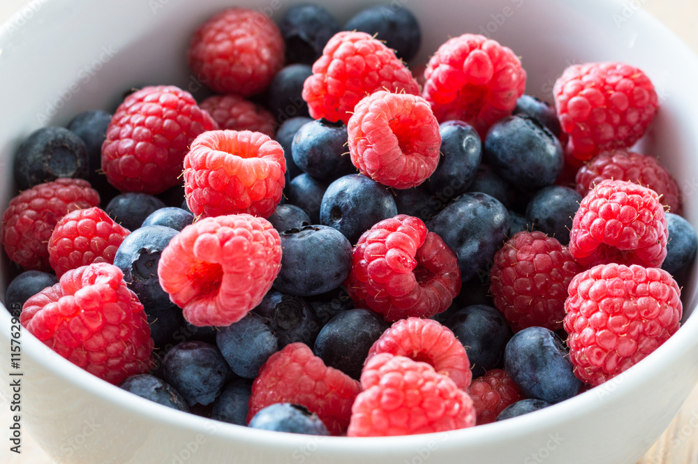 Bowl of fresh blueberries and raspberries Bowl of fresh blueberries and raspberries
