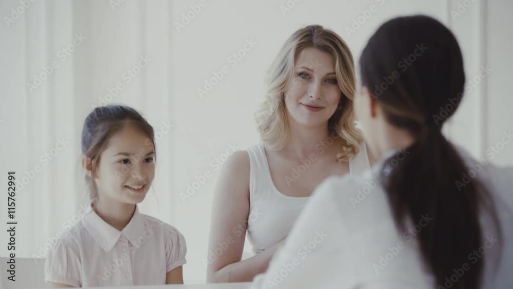 Doctor consulting family pregnant mother with daughter in a hospital. 4K Doctor consulting family pregnant mother with daughter in a hospital. 4K