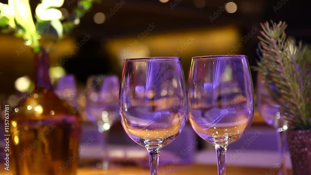 Empty wine glasses on a wooden table at a restaurant - Tilt up. Empty wine glasses on a wooden table at a restaurant - Tilt up.