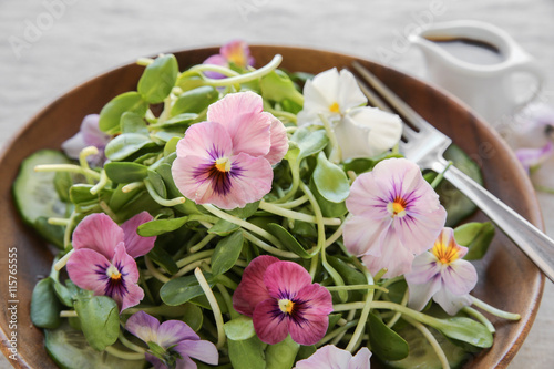 фотографія Sunflower sprouts, cucumber and edible flowers salad, vegan food