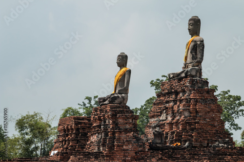 row of ruin buddha statue in wat chai wattanaram, ayutthaya, tha photo