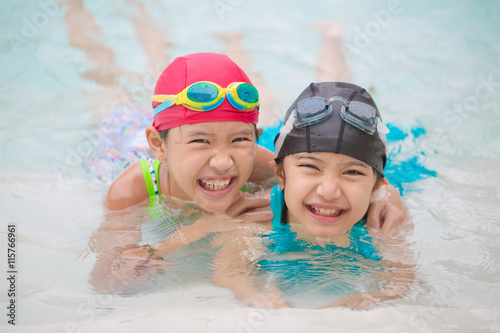 Happy Asian sibling girl playing in the swimming pool © RedcupStudio