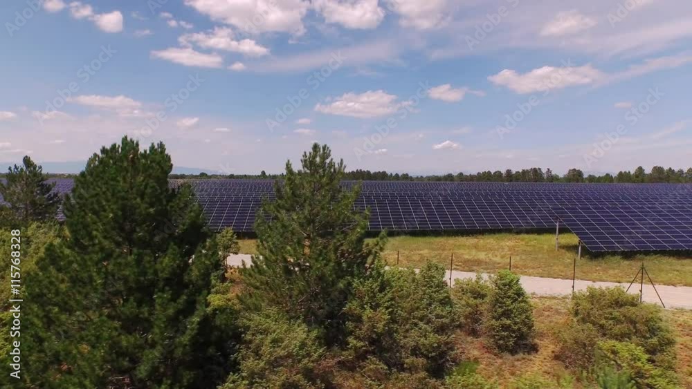 AERIAL: Large solar panel plant on a big sunny field AERIAL: Large solar panel plant on a big sunny field