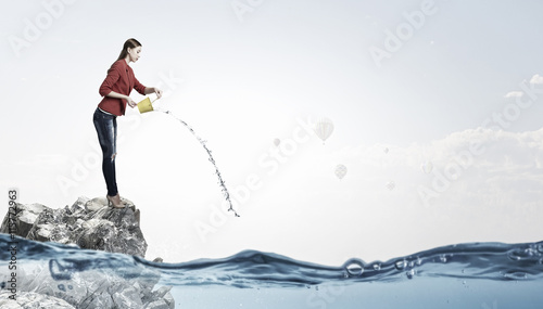 Girl pouring water from bucket . Mixed media