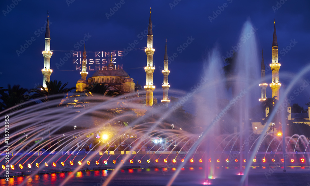 The evening illumination of fountain and Blue mosque with mahya