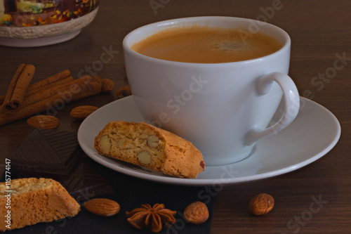 Cup of coffee and cookies with cinnamon