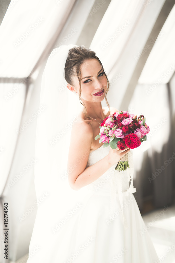 Beautiful bride with wedding bouquet posing in old city Beautiful bride with wedding bouquet posing in old city