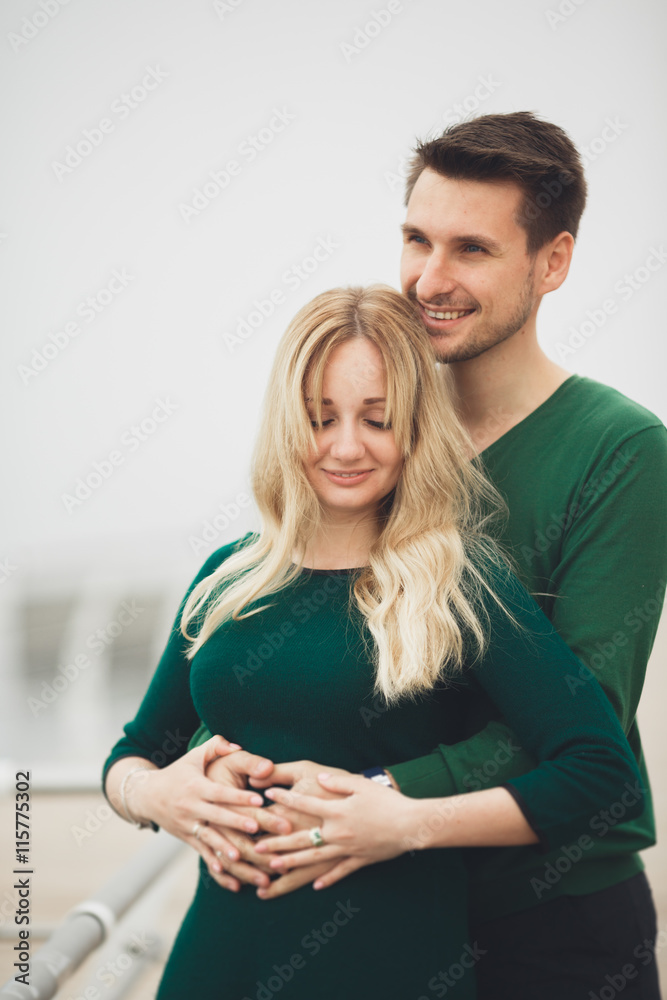 Fototapeta premium Lovely couple kissing and hugging on a sea dock