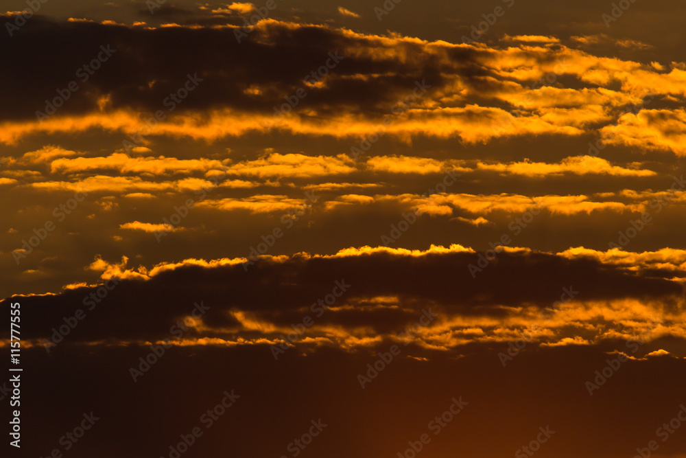 Dark, orange and dramatic cloudscape in the sunlight Dark, orange and dramatic cloudscape in the sunlight