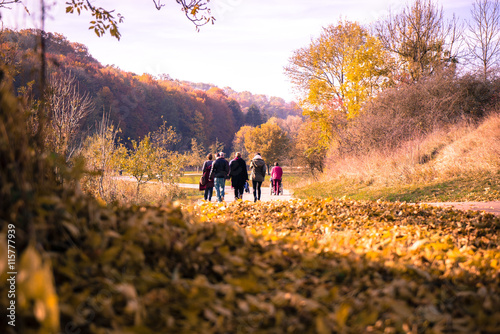 family walking in autumnal park