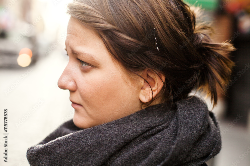 Profile of woman wearing black scarf outdoors Profile of woman wearing black scarf outdoors