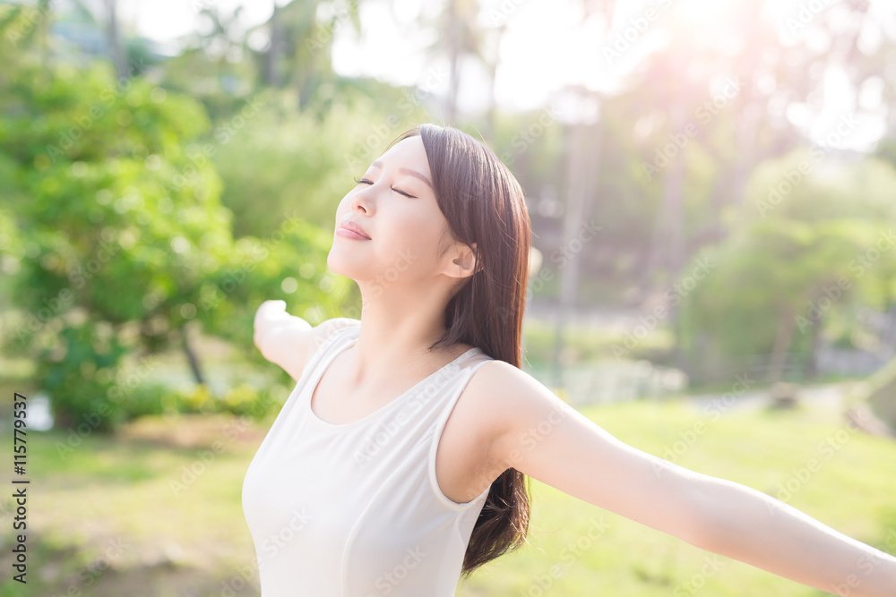 young woman raising her arms