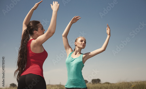 Young women doing yoga outdoors photo stay and poses