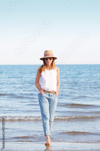 Perfect summer day by the sea. Beautiful woman relaxing at seaside