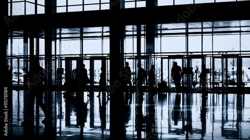 Silhouettes of people in modern lobby