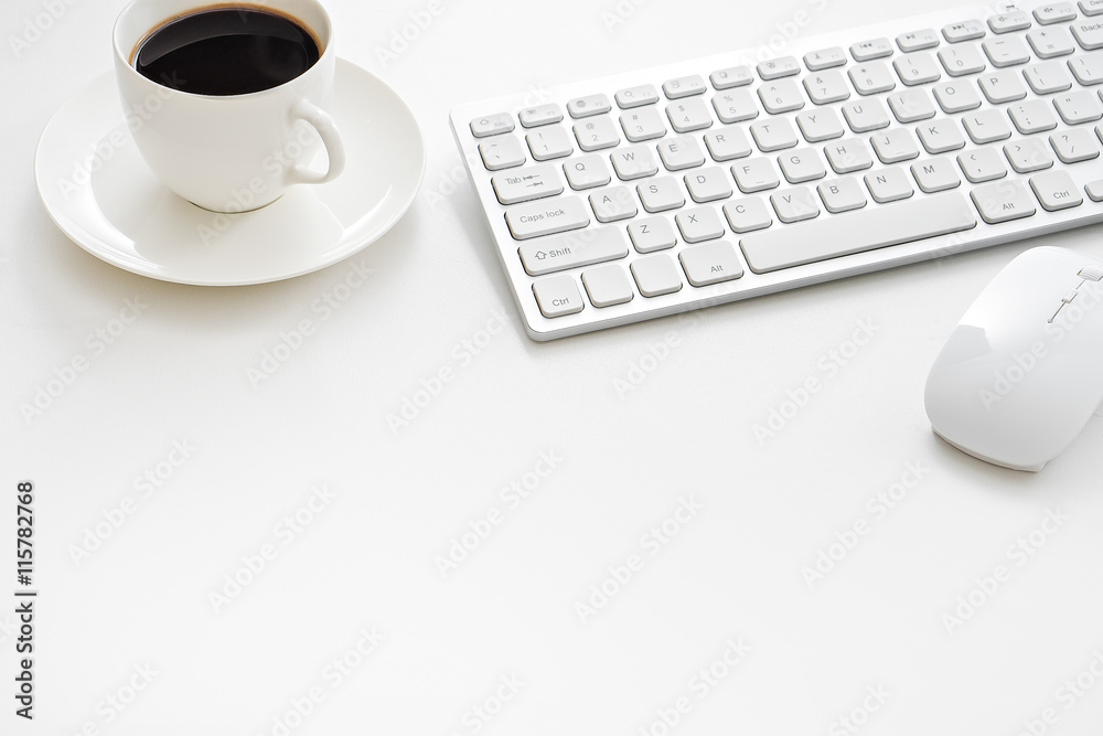 Office desk table with computer, supplies and coffee cup