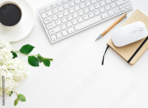 Office desk table with computer, supplies and coffee cup