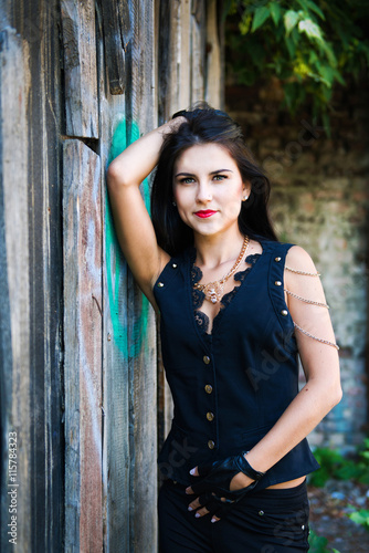 Pretty young woman near wooden wall