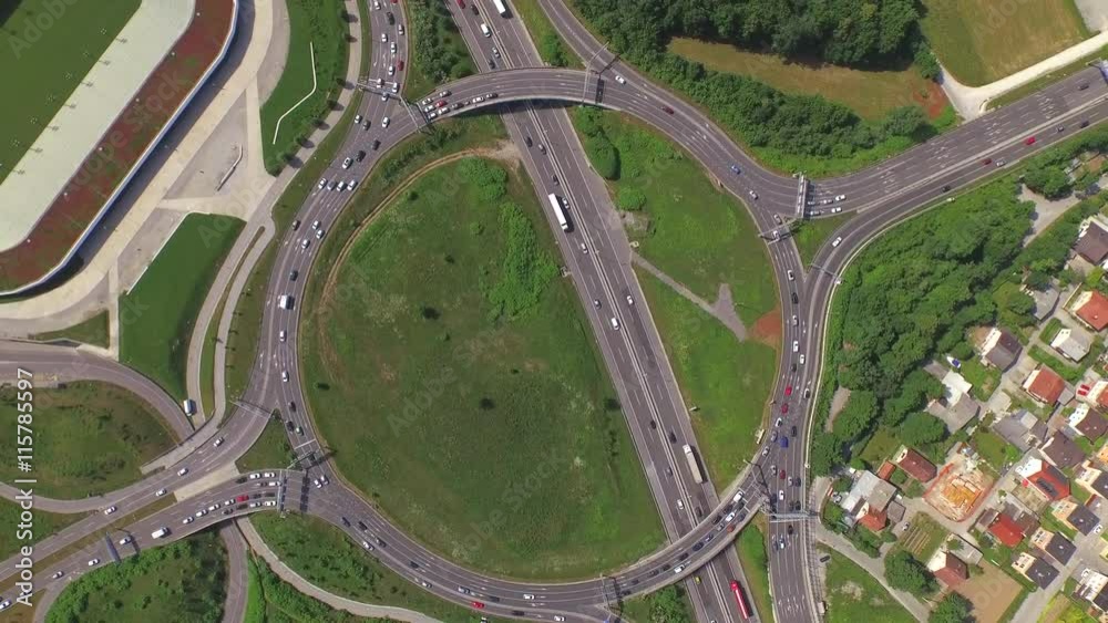 AERIAL: Flying above huge roundabout full of cars and trucks AERIAL: Flying above huge roundabout full of cars and trucks
