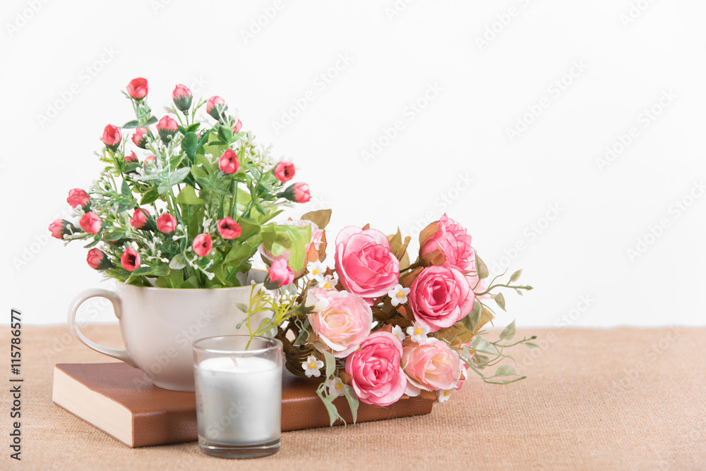 interior decoration pink rose flower in a vase with book