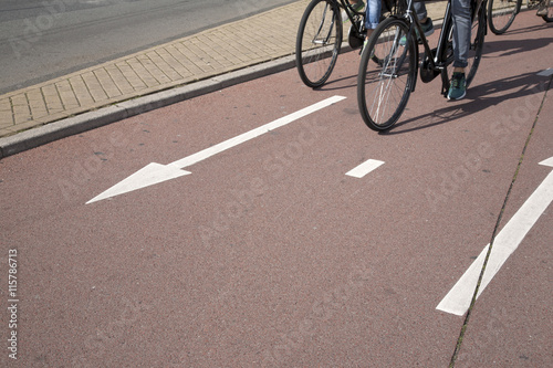 Obraz na płótnie Bike Lane with Cyclist in Amsterdam; Holland w salonie