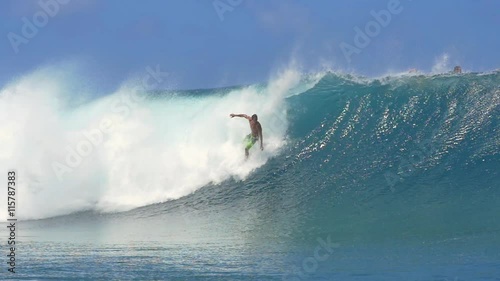 SLOW MOTION: Surfer surfing big tube barrel wave and falls