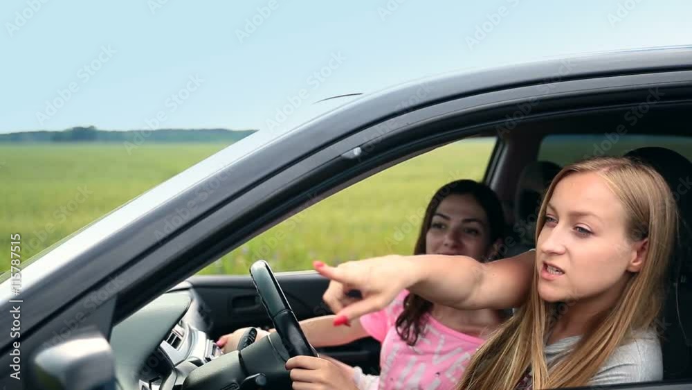 Pretty girls traveling countryside by car Pretty girls traveling countryside by car