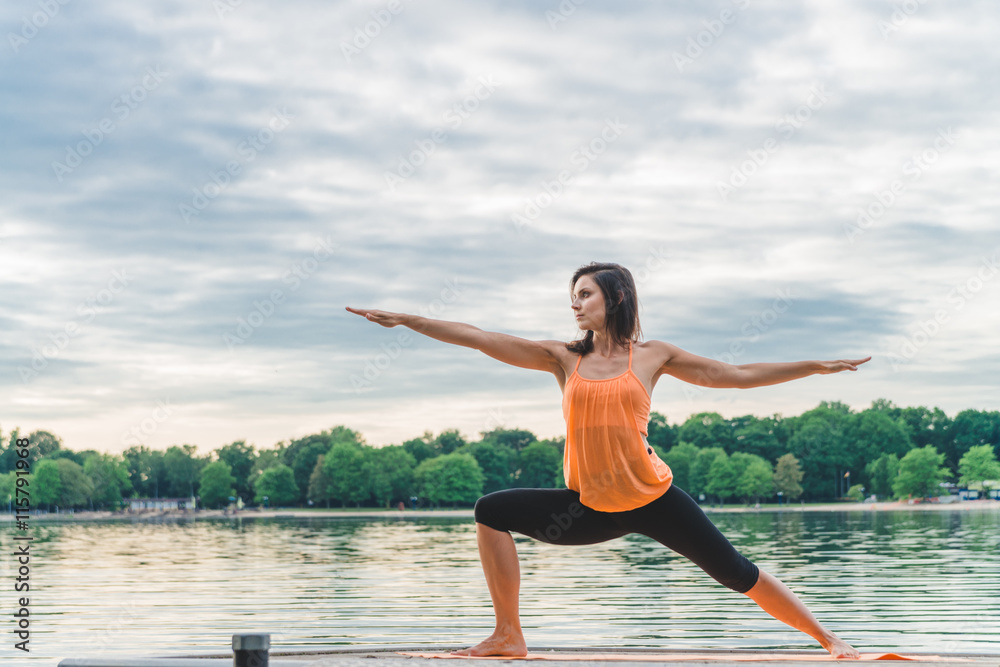 Young woman doing yoga on the lake Young woman doing yoga on the lake